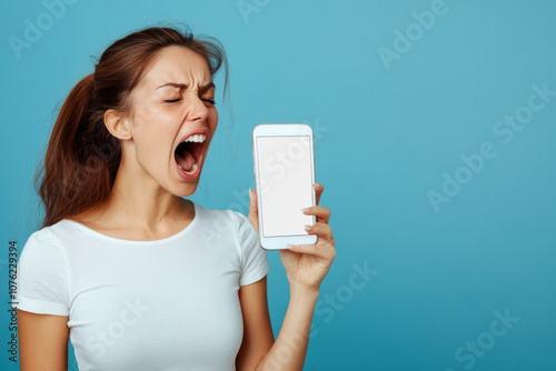 A woman is holding a smartphone with an empty screen. An annoyed girl screams at the phone with her eyes closed on a blue background