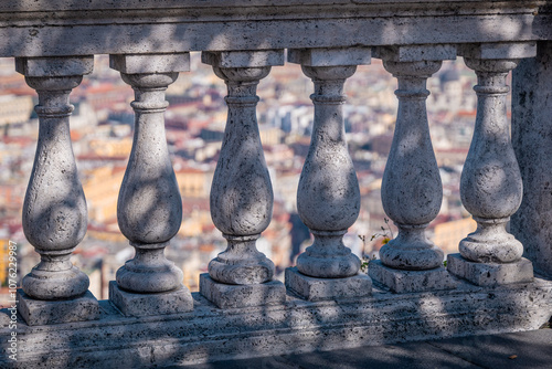 Concrete fence or marble wall overlooking the city of Napoli on a sunny summer or autumn day. Typical marble pillars above the city of Naples at the saint elmo fortress... photo