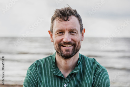 Portrait adult man with beard with sea on background. photo