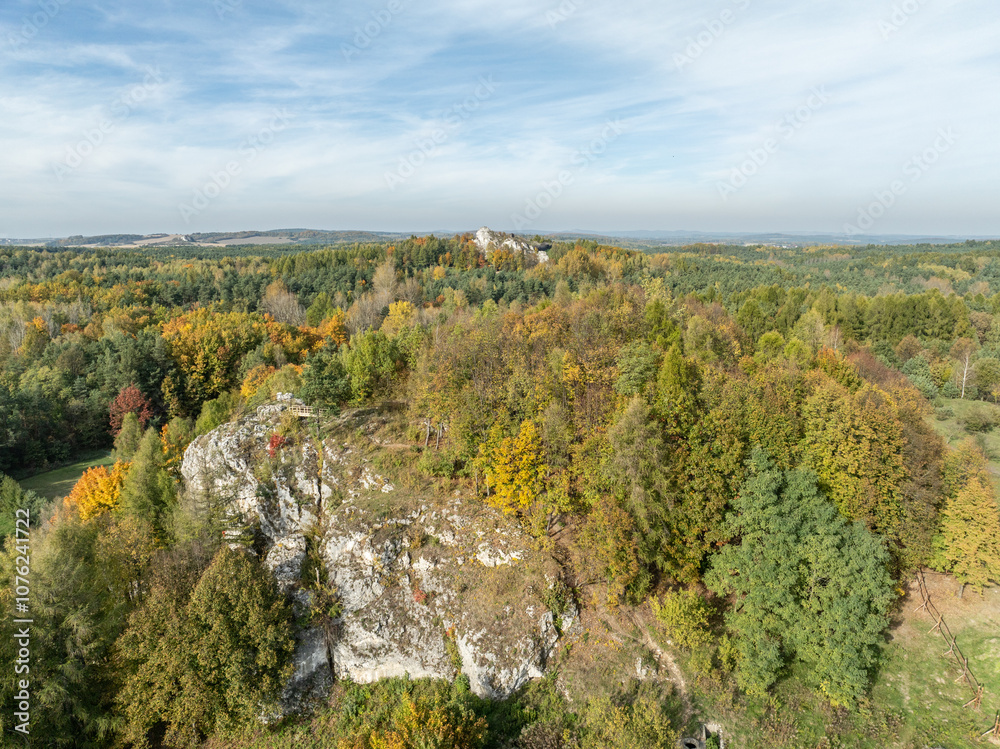 Aerial drone view of stronghold on Birow Hill. Reconstructed stronghold on Birow Hill in the Czestochowa Upland in the village of Podzamcze,Ogrodzieniec, Poland. Limestone rock hill in autumn. Aerial drone view of stronghold on Birow Hill. Reconstructed stronghold on Birow Hill in the Czestochowa Upland in the village of Podzamcze,Ogrodzieniec, Poland. Limestone rock hill in autumn.