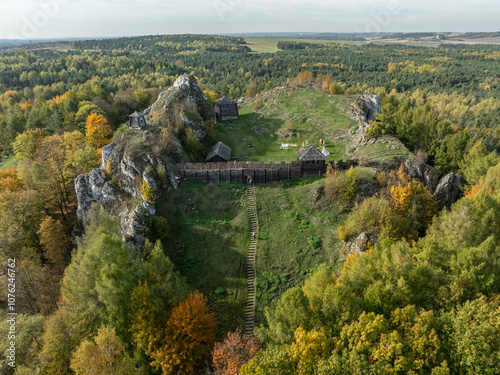 Aerial drone view of stronghold on Birow Hill. Reconstructed stronghold on Birow Hill in the Czestochowa Upland in the village of Podzamcze,Ogrodzieniec, Poland. Limestone rock hill in autumn. photo