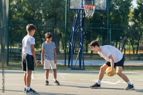 Canvastavla Boys participate in outdoor basketball training with a coach, focusing on teamwo