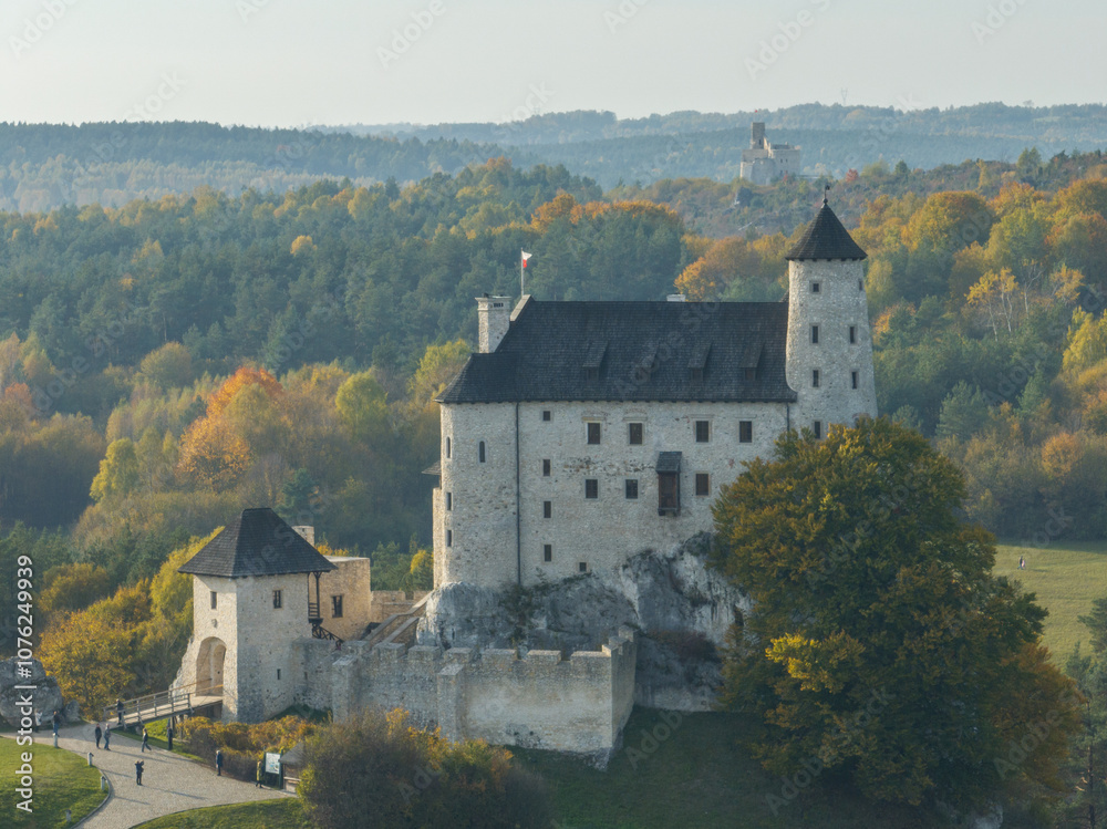 Aerial drone view of Bobolice Castle in autumn.Old medieval fortress, royal castle in the village of Bobolice, Poland.Strongholds Eagles Nests in Polish Jurassic Highland.Limestone rock castle ruins. Aerial drone view of Bobolice Castle in autumn.Old medieval fortress, royal castle in the village of Bobolice, Poland.Strongholds Eagles Nests in Polish Jurassic Highland.Limestone rock castle ruins.