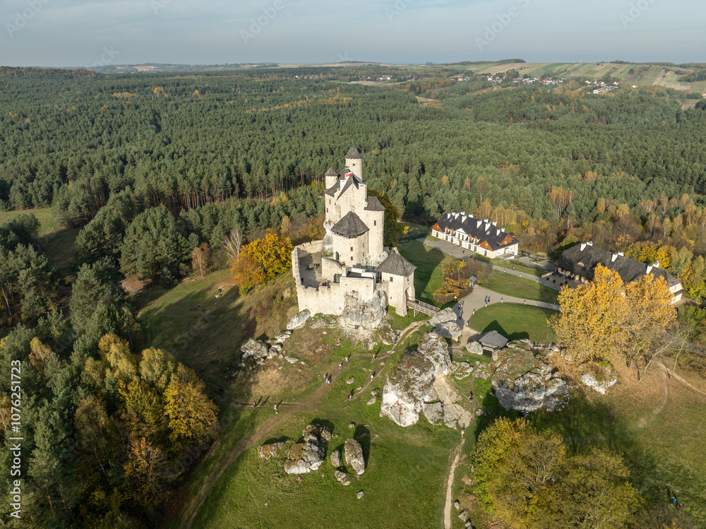 Fototapeta premium Aerial drone view of Bobolice Castle in autumn.Old medieval fortress, royal castle in the village of Bobolice, Poland.Strongholds Eagles Nests in Polish Jurassic Highland.Limestone rock castle ruins.