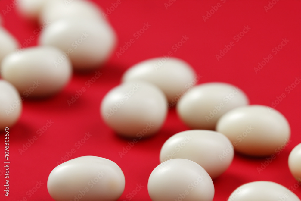 Small round candies lying on red and white lifestyle. lie eat concept. a small round candies lying on a red and white lifestyle. a small round candies with a sweet treat on the side lifestyle. Small round candies lying on red and white lifestyle. lie eat concept. a small round candies lying on a red and white lifestyle. a small round candies with a sweet treat on the side lifestyle.