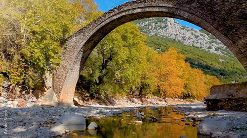 Autumn view of the famous Portaikos arched, stonebridge in Trikala, Greece photo