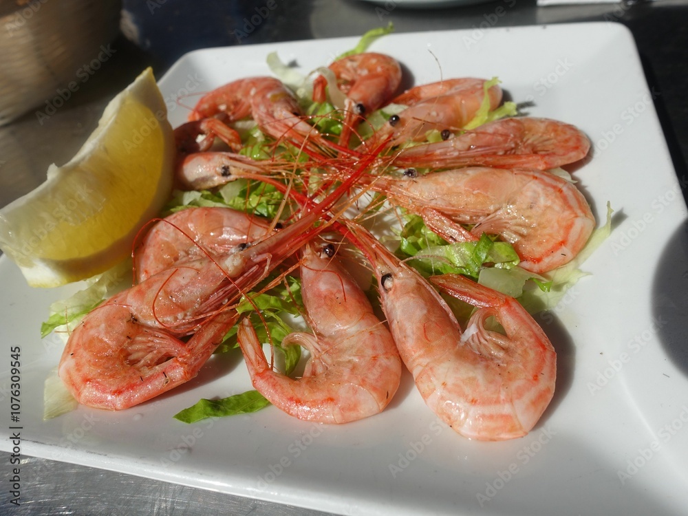 Fresh shrimp plate with lemon and lettuce garnish. Fresh shrimp plate with lemon and lettuce garnish.