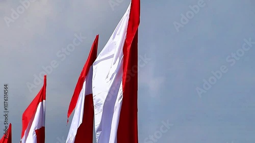 Red and white pennants flutter proudly in the wind