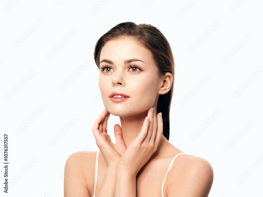 Beautiful young woman posing with hands on face, isolated on white background Beautiful young woman posing with hands on face, isolated on white background
