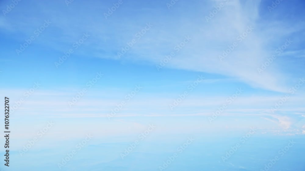 Aerial view of white clouds, from airplane window with blue sky