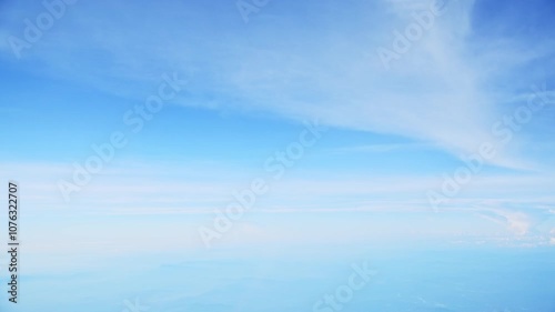 Aerial view of white clouds, from airplane window with blue sky