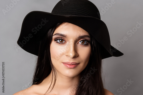 Girl in and with hat on gray. person concept. girl in and gray with hat on a gray. a girl in gray with a hat on and a the lifestyle lifestyle.