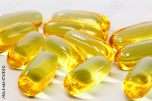 Green yellow capsules of fish oil on a. food lifestyle concept. vitamin nutrition concept. a green and yellow capsules of fish and oil on a. food and lifestyle concept. a healthy lifestyle with.