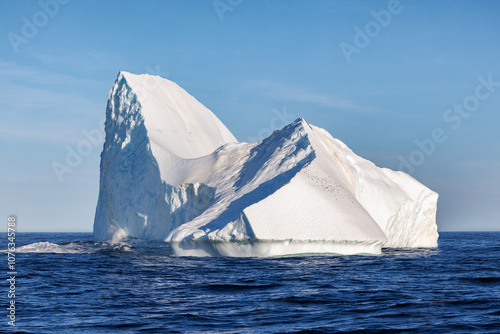 Huge sculptural iceberg in Liverpool Land, Eastern Greenland. This is a freshwater iceberg that has calved from a glacier and floated out to sea. A flock of kittiwakes are fishing from here.