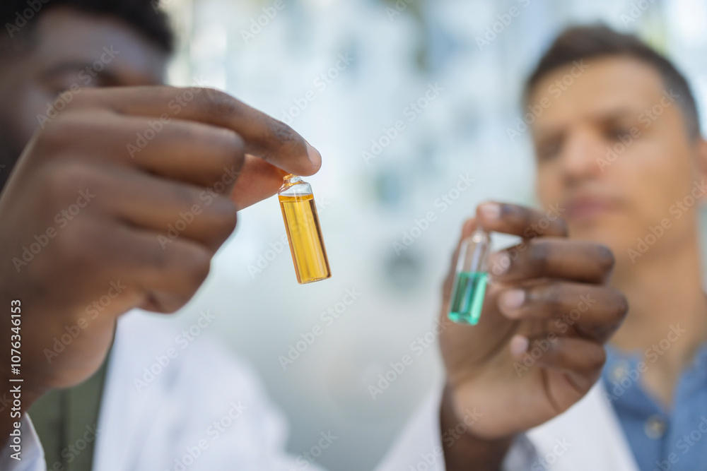 Pharmacists examining vials at pharmacy Pharmacists examining vials at pharmacy