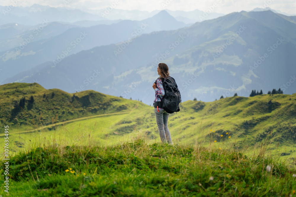 Woman backpacker looking at view during hiking Woman backpacker looking at view during hiking