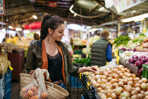 Woman shopping for fresh fruits and vegetables at the city market photo