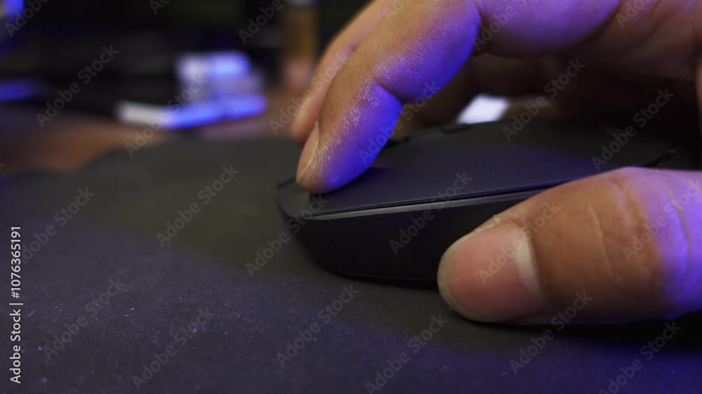 Click black computer mouse on a work desk. Click and scrolling computer mouse. A male hand holding a computer mouse. Click black computer mouse on a work desk. Click and scrolling computer mouse. A male hand holding a computer mouse.
