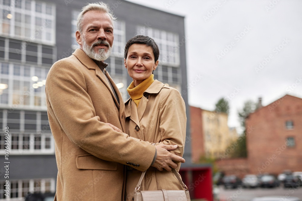 Portrait of senior couple hugging each other on a walk in the city Portrait of senior couple hugging each other on a walk in the city