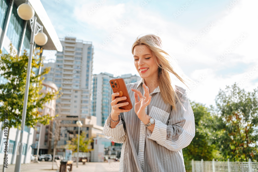 Smiling young woman using mobile phone in city Smiling young woman using mobile phone in city