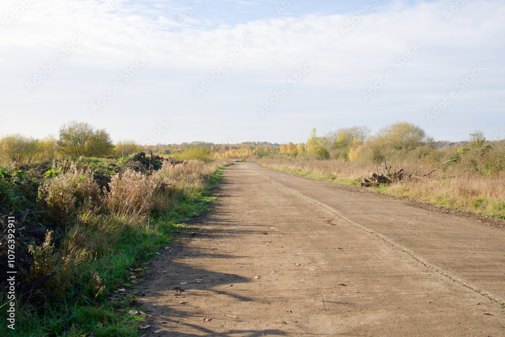 Long straight deserted road through wasteland Long straight deserted road through wasteland