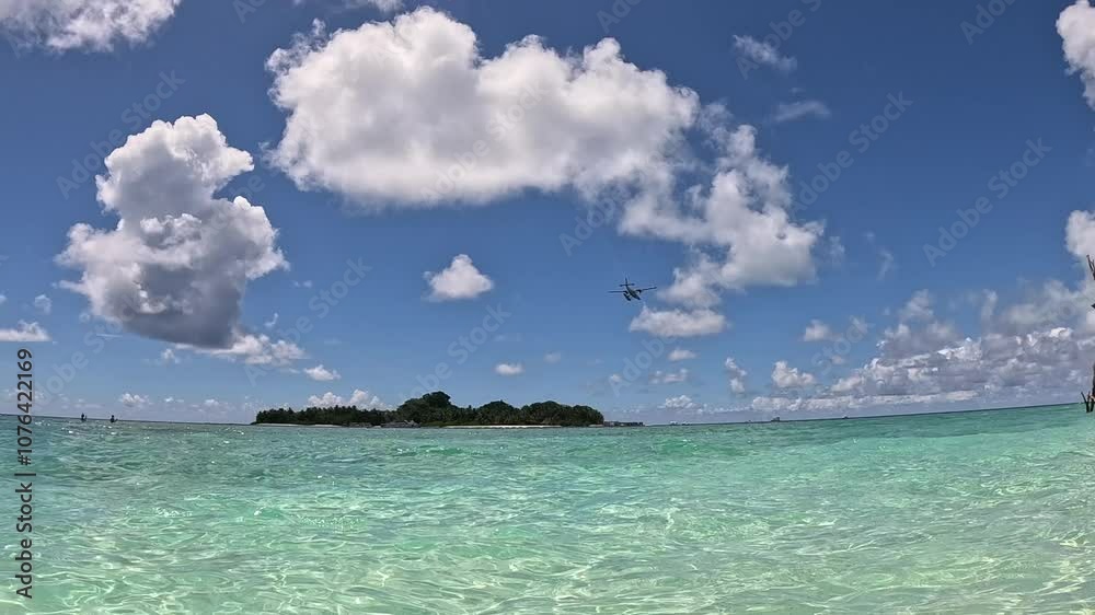 Sea plane airplane flying over tropical island in the maldives Sea plane airplane flying over tropical island in the maldives