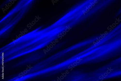 Defocused abstract blue background of speed camera movement over glowing lights. A pattern of flashes of light similar to the northern lights