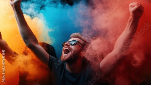 A joyful person with sunglasses is celebrating enthusiastically amid brightly colored powder clouds, capturing a moment of happiness and free-spirited excitement. photo