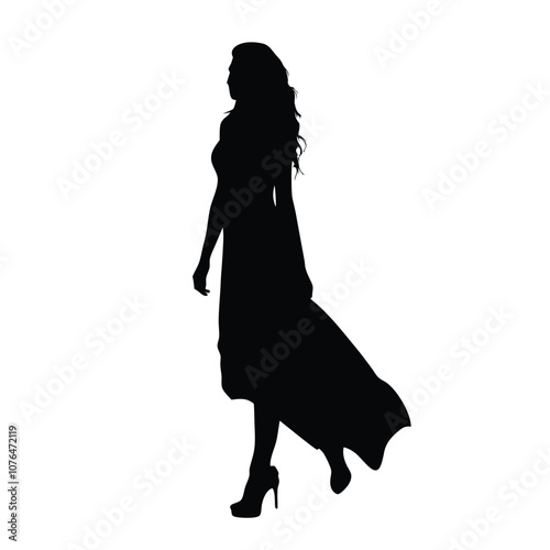 A woman in a long dress is walking on a white background. She is wearing high heels