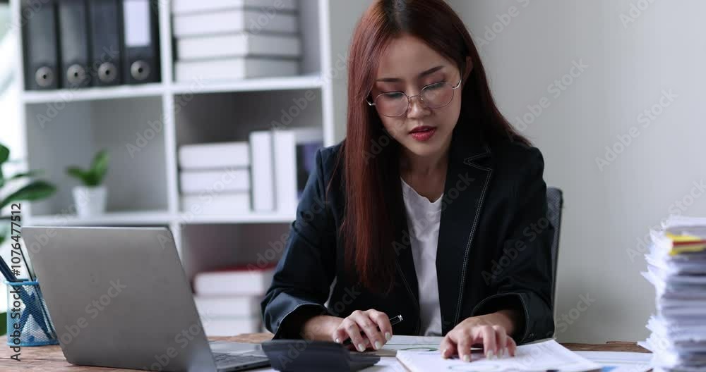 Asian Business woman using calculator and laptop for doing math finance on an office desk, tax, report, accounting, statistics, and analytical research concept
Asian Business woman using calculator and laptop for doing math finance on an office desk, tax, report, accounting, statistics, and analytical research concept