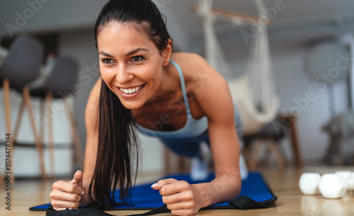Fit young woman doing exercise, workout at home, training in living room to stay healthy Free Download Fit young woman doing exercise, workout at home, training in living room to stay healthy - GFXLoad
