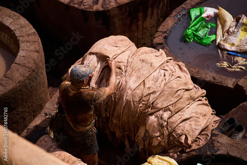 People works in the Shuara leather dyeing factory. Traditional Moroccan craft. photo