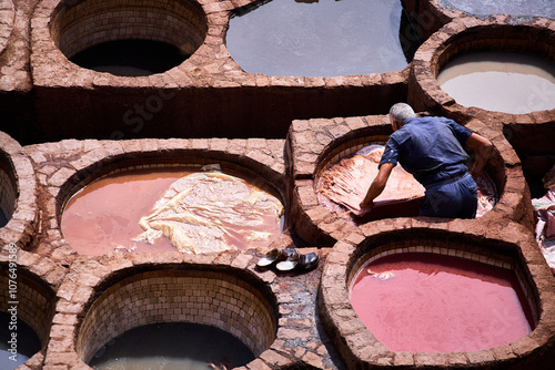 People works in the Shuara leather dyeing factory. Traditional Moroccan craft. photo