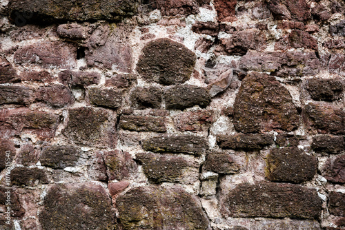 Obraz na płótnie A wall made of stone with a rough texture. The wall is brown and white w salonie