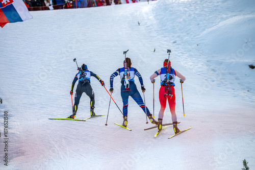 Biathlon athletes on the snowy track while winter sport professional race