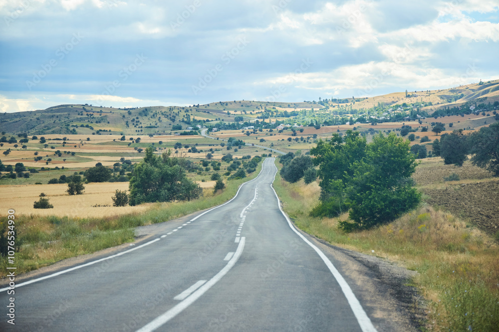 A beautiful landscape with a road stretching into the distance. The Anatolian region of Turkey. The time of the year is summer.