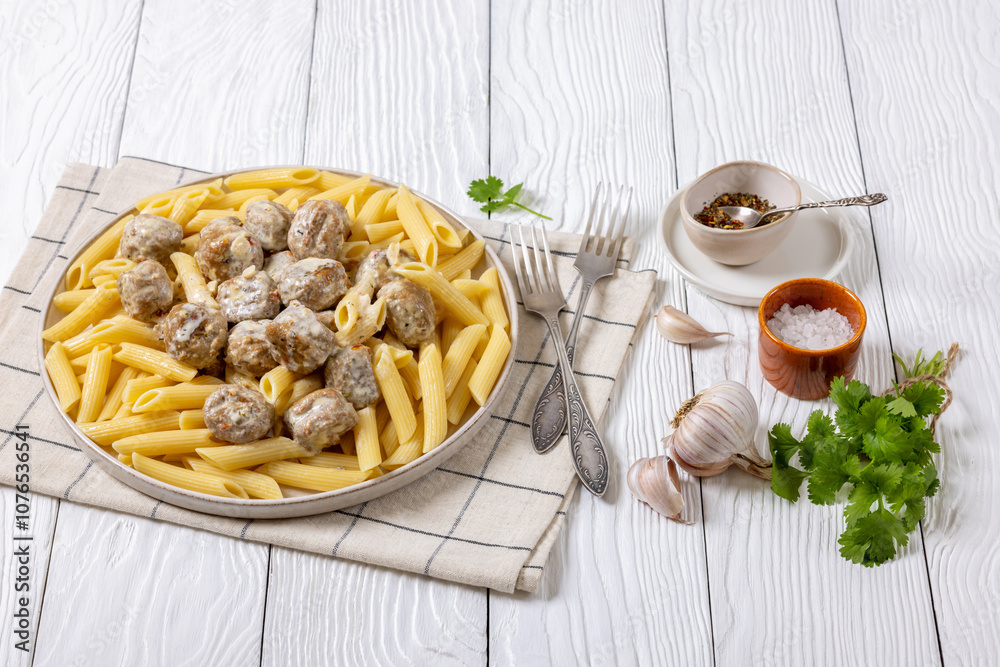 Ground chicken meatballs with penne pasta on plate Ground chicken meatballs with penne pasta on plate