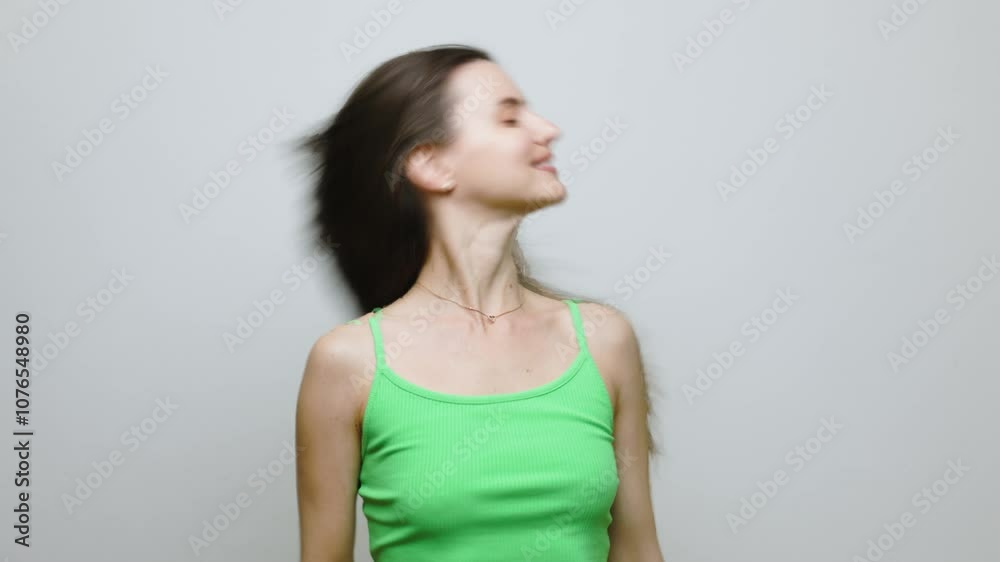 Fashion model looking at the camera, tossing her hair, looking seductive, smiling. In studio, on white background. Fashion model looking at the camera, tossing her hair, looking seductive, smiling. In studio, on white background.