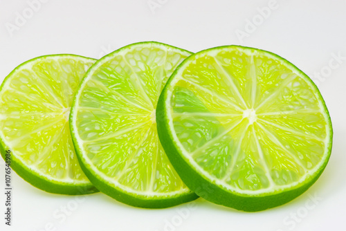 White with fruit and lime. fresh food concept. a plate of greens and slices of lime on a white . a plate of fruit with slices of limes, greens and lifestyle whites on a. photo