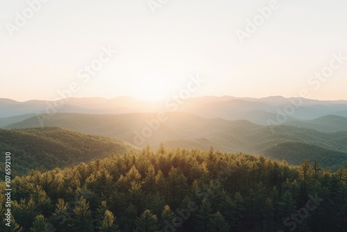 Mountain range with fore at sunset, with the sun setting behind them.  photo