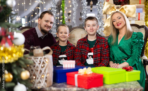 Family with mom and dad celebrates Christmas at home