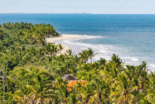 TRANCOSO, BAHIA STATE, BRAZIL: aerial view, tourists enjoying perfect tropical beach with white sand, palm trees, turquoise water and small waves, near Porto Seguro