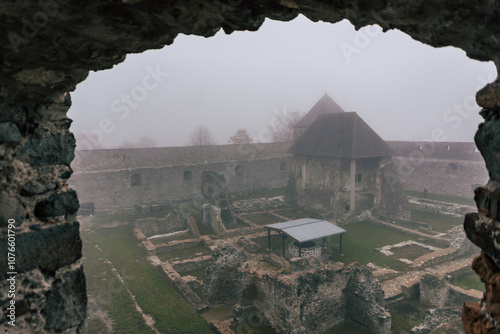 Medieval castle fort Bzovík or Bozók in foggy weather photo