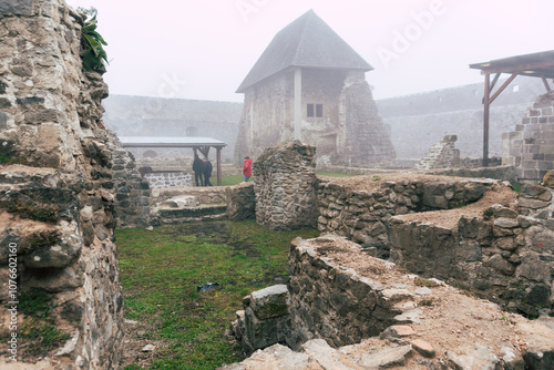 Medieval castle fort Bzovík or Bozók in foggy weather photo