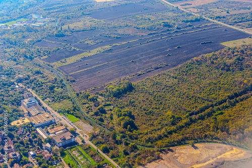 Aerial view of valley with farm fields, pond and Danube river. High quality photo