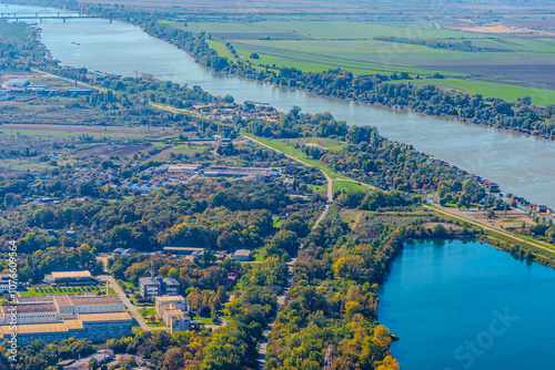Aerial view of valley with farm fields, pond and Danube river. High quality photo