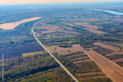 Aerial view of valley with farm fields, pond and Danube river. High quality photo
