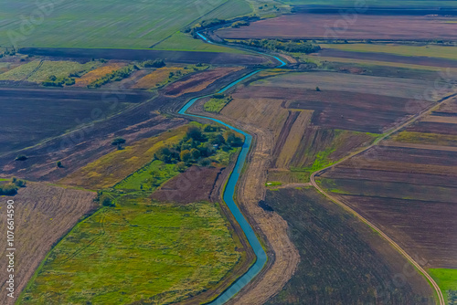 Aerial view of valley with farm fields, pond and Danube river. High quality photo