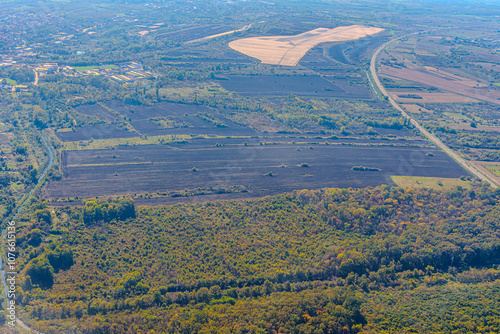 Aerial view of valley with farm fields, pond and Danube river. High quality photo