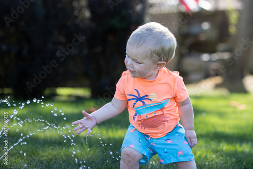 little child playing with water